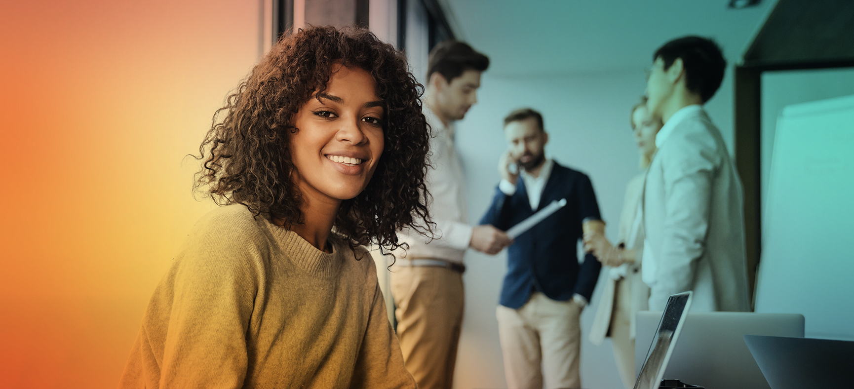 Woman in an Office Asks Which Loans Are Available for Small Businesses