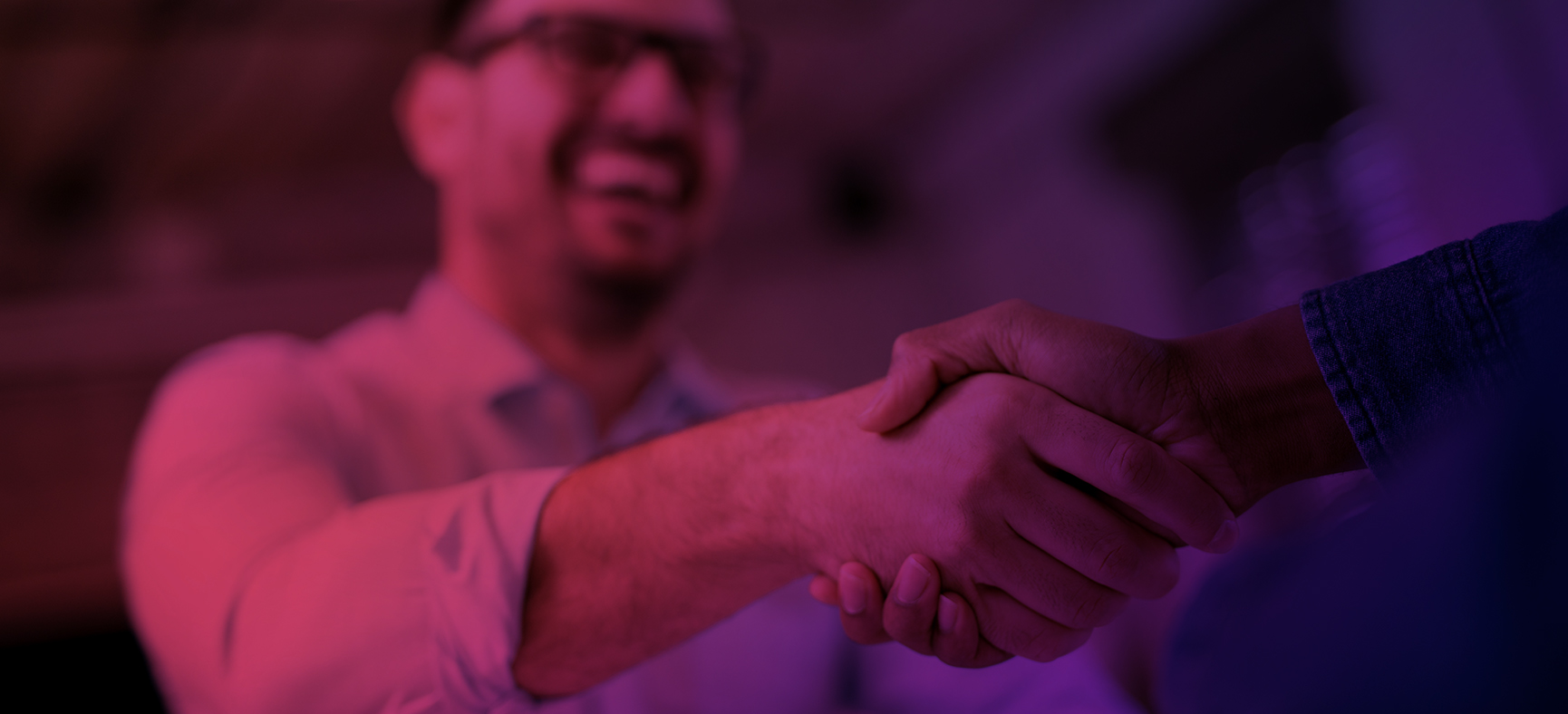 Personal Guarantor for a Business Loan Shakes Hands with Another Man as He Raises Funds for His Small Business