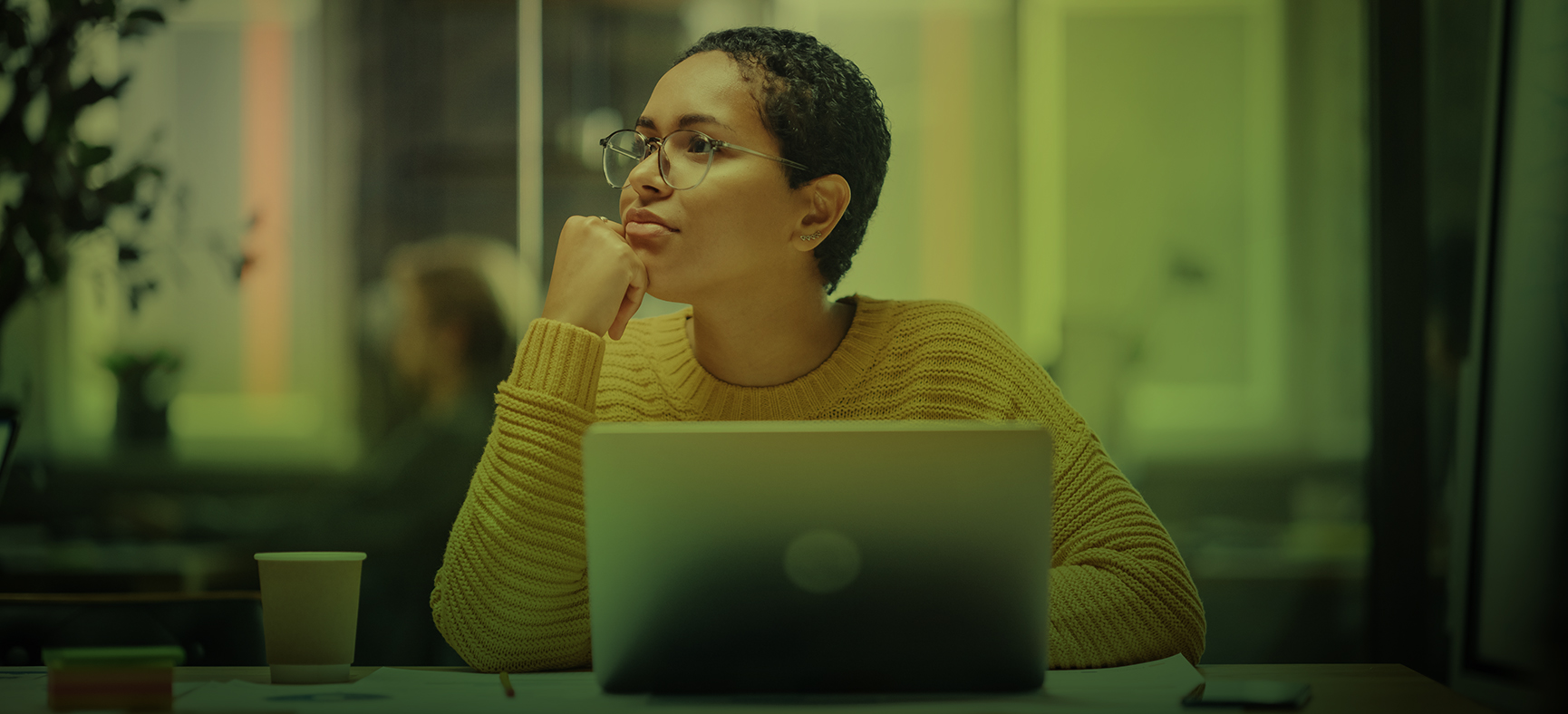 A woman sits at a desk and thinks about what is branding