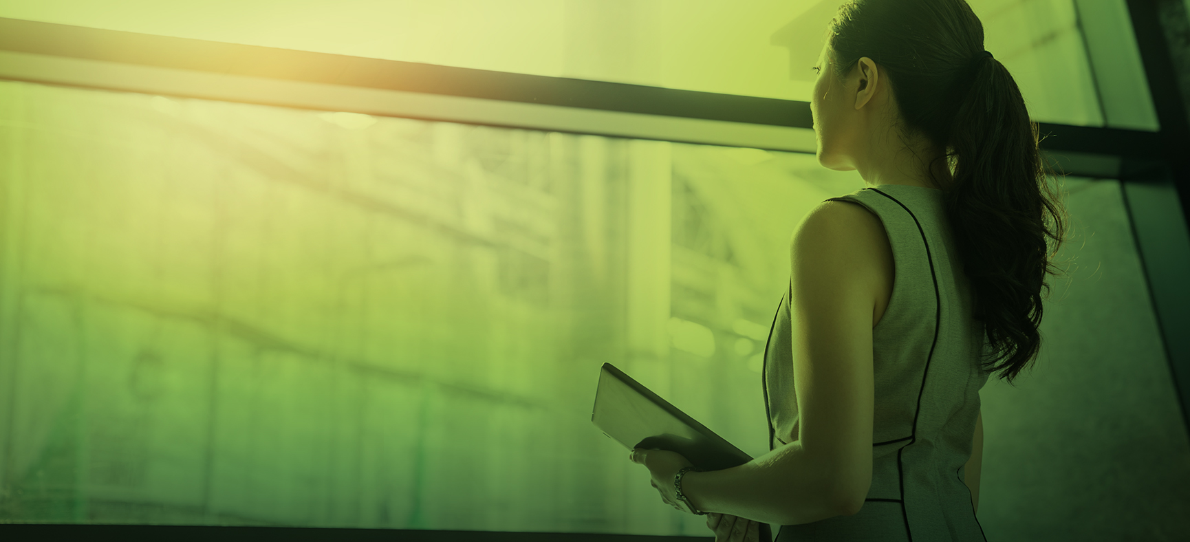 Woman looks out an office window and think about the future of her business