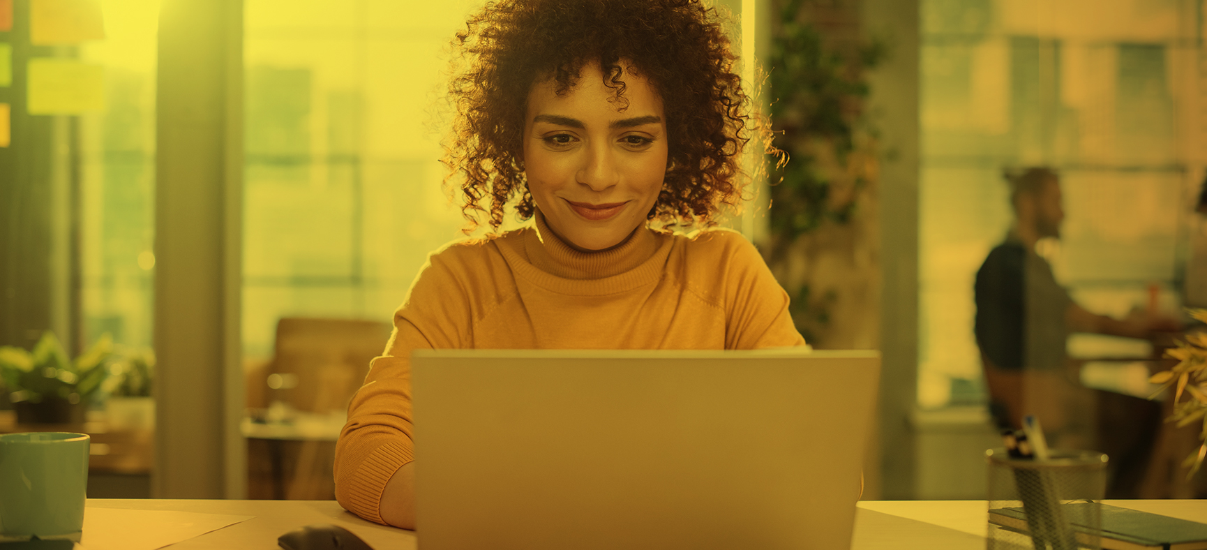 Women types at her computer and improves her business writing.