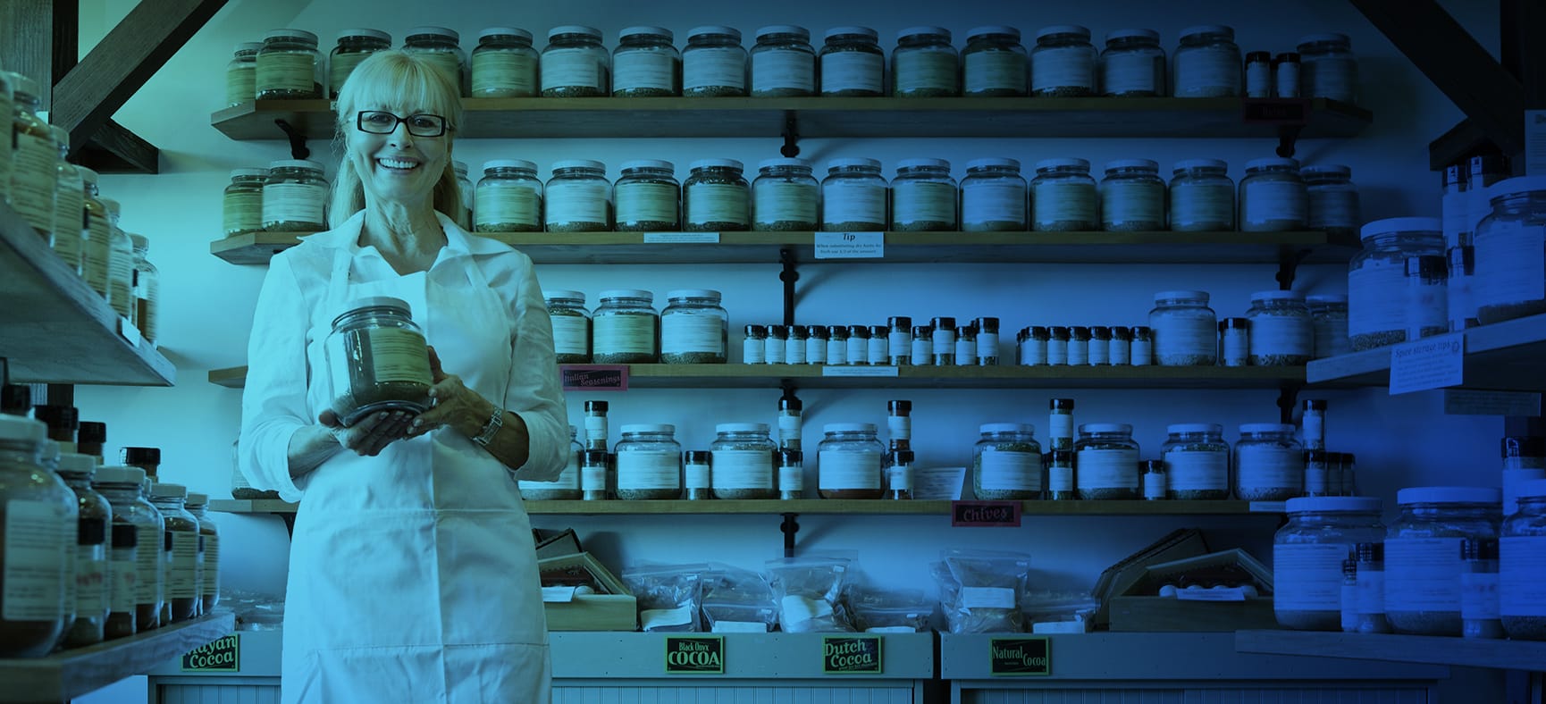 Small business owner stands in her shop and needs support to grow