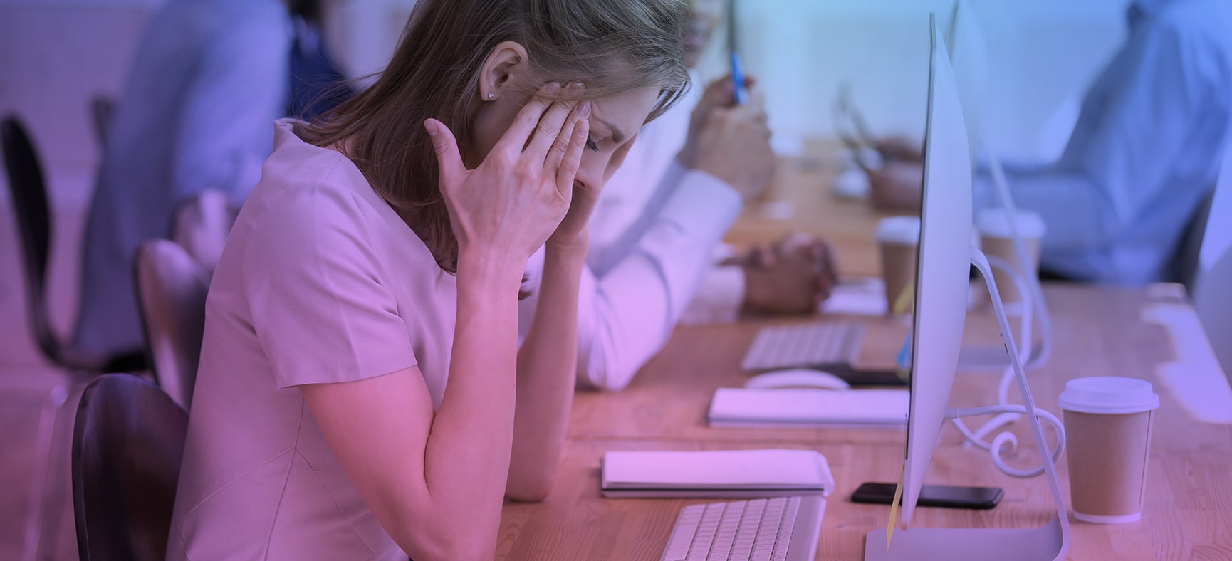 Employee struggles with mental health at her office desk