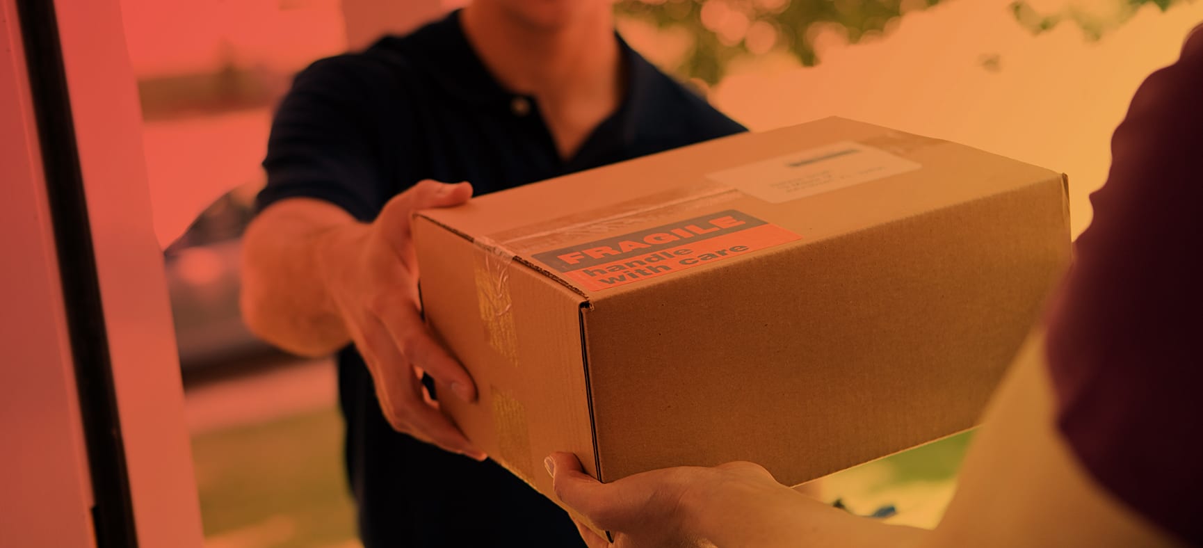 Delivery man hands a customer custom shipping materials