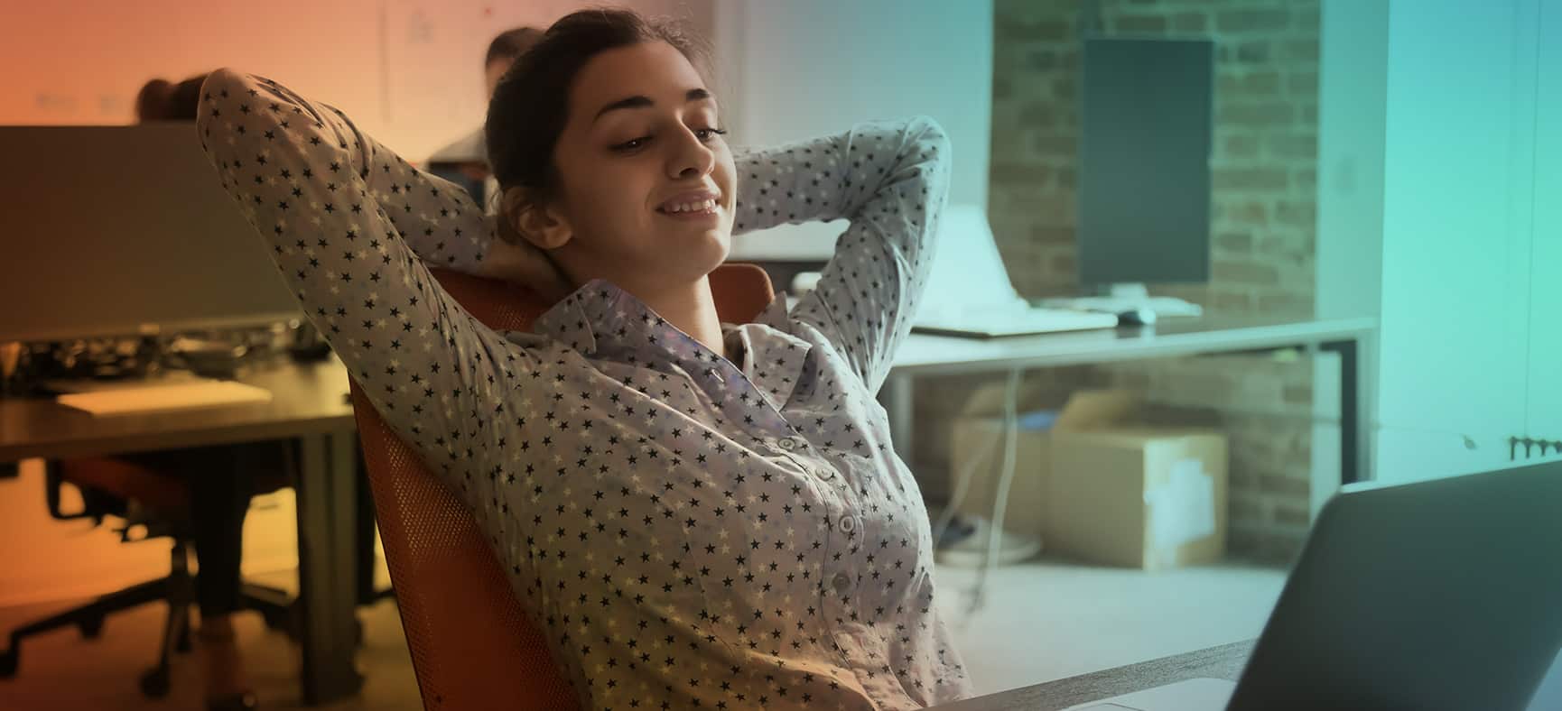 Woman takes a break at her desk to improve workplace mental health