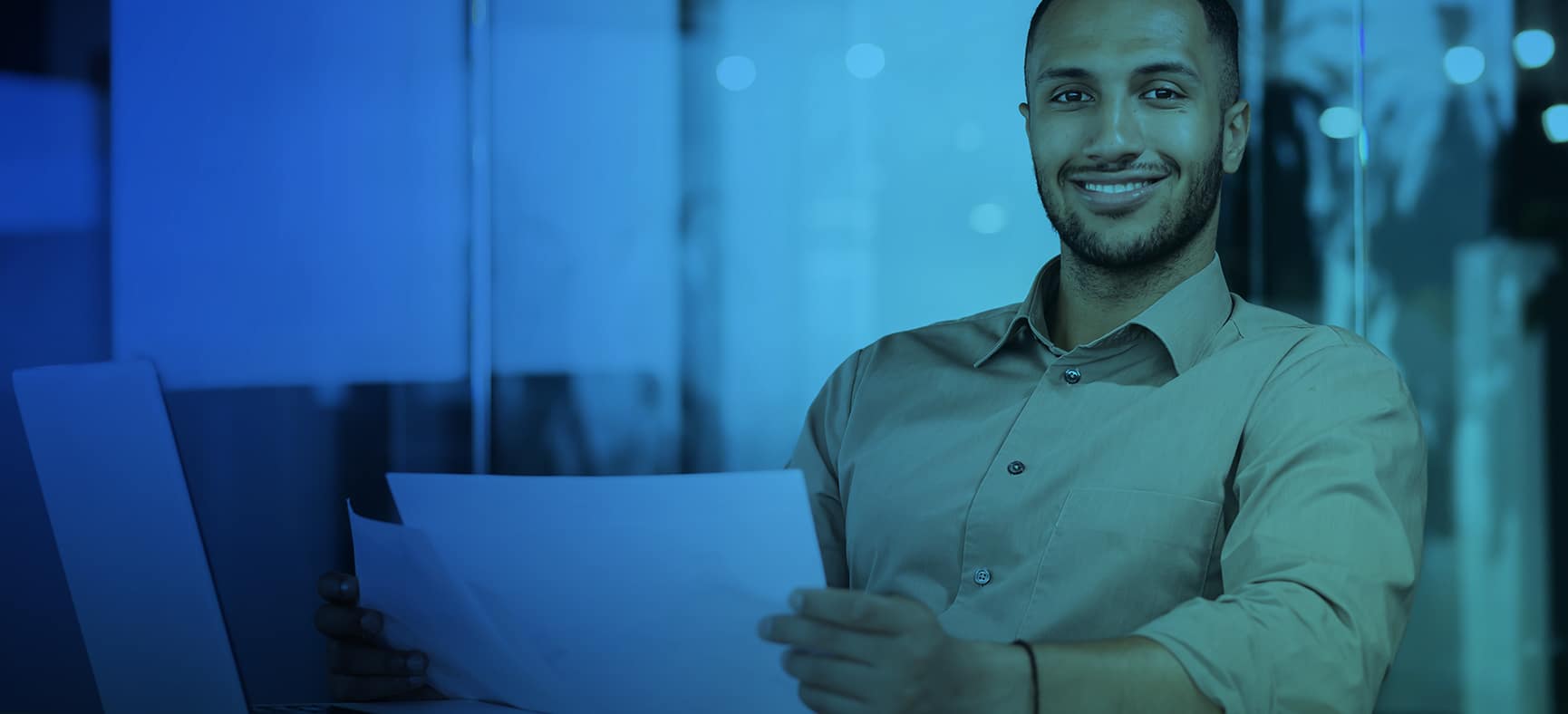 Accountant sits at his computer and reviews accounting documents for small business