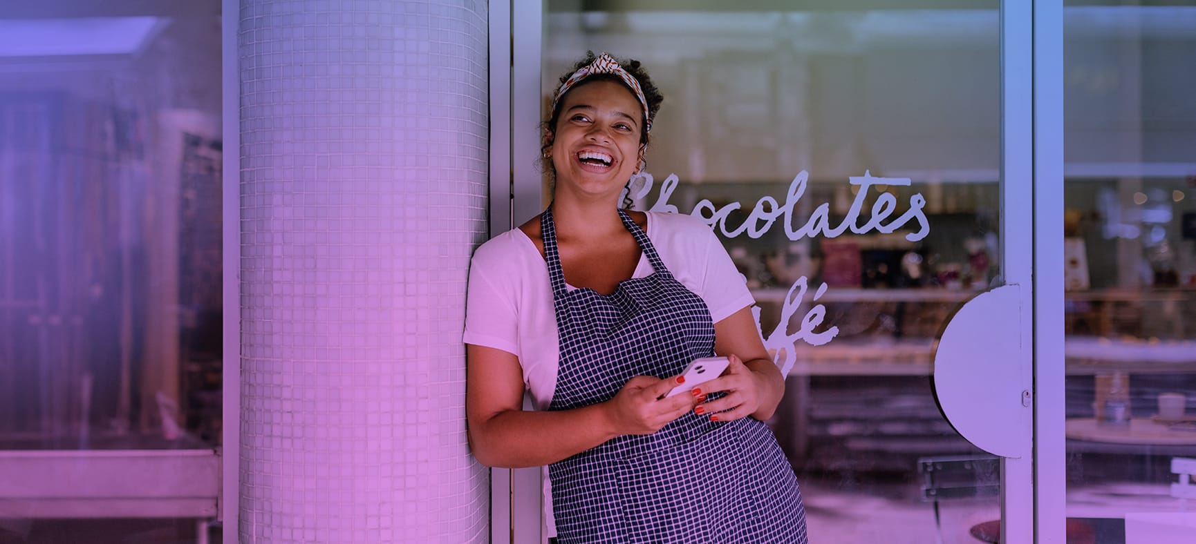 Small business owner stands in front of her shop