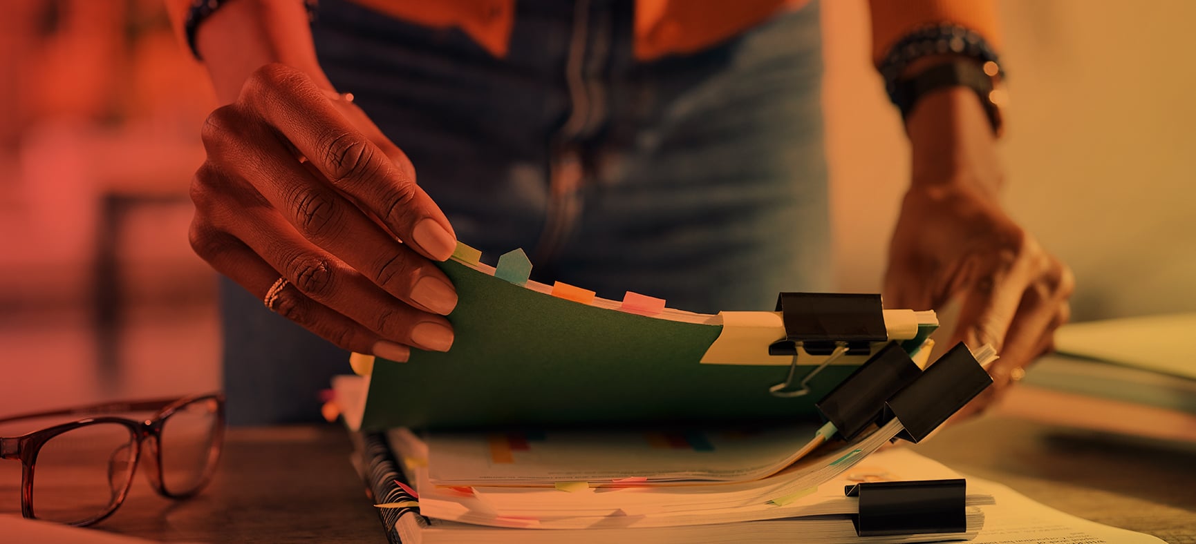 Woman sorts through papers and business documents