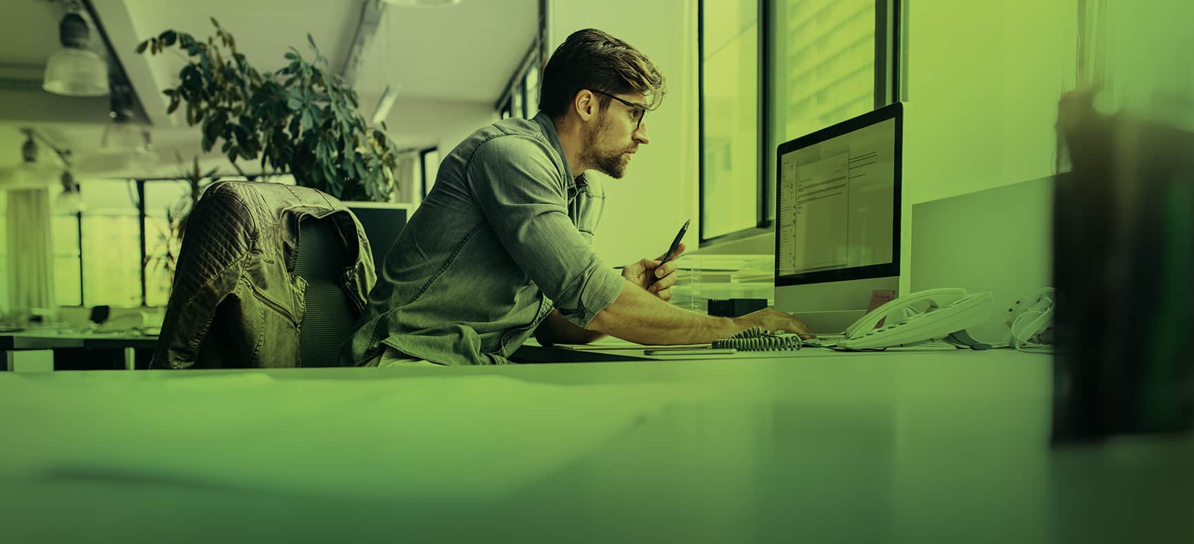 Man Sits at Desk and Considers Whether to File a BOI Report After Dissolving the Business