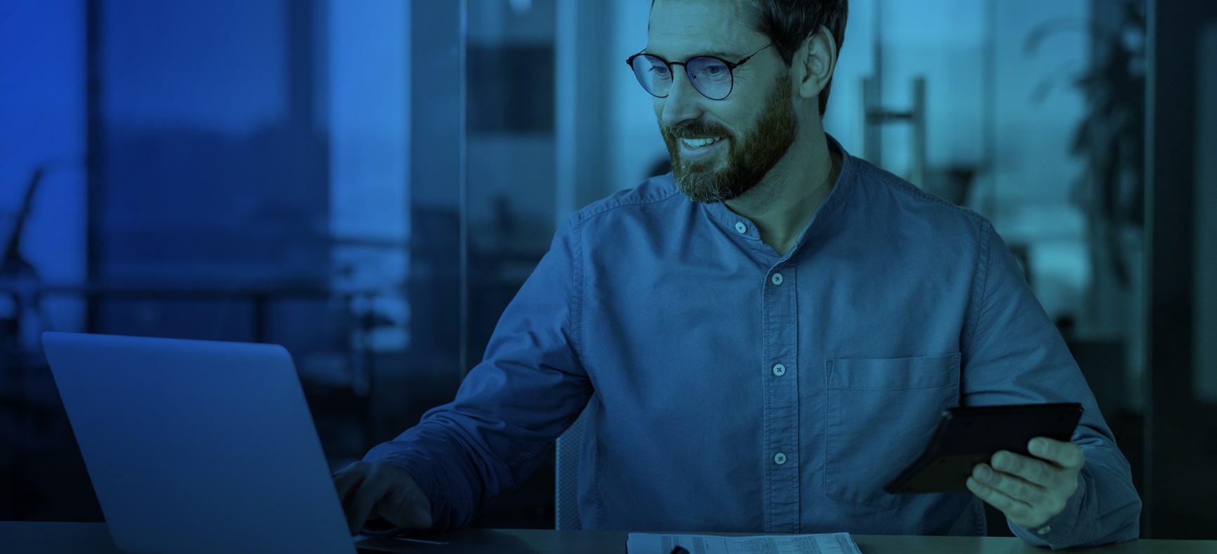 Man sits at desk and searches to find the right tax professional on his computer