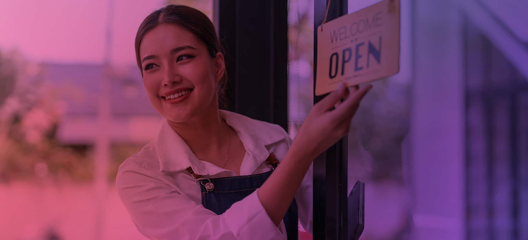 Woman flips a small business open sign