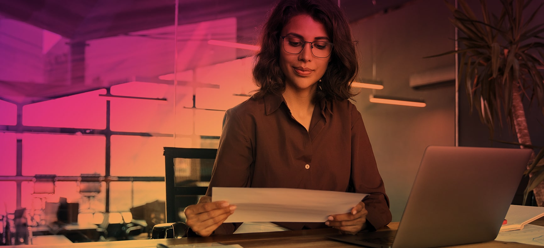 Businesswoman sits at desk and works on year end tax planning