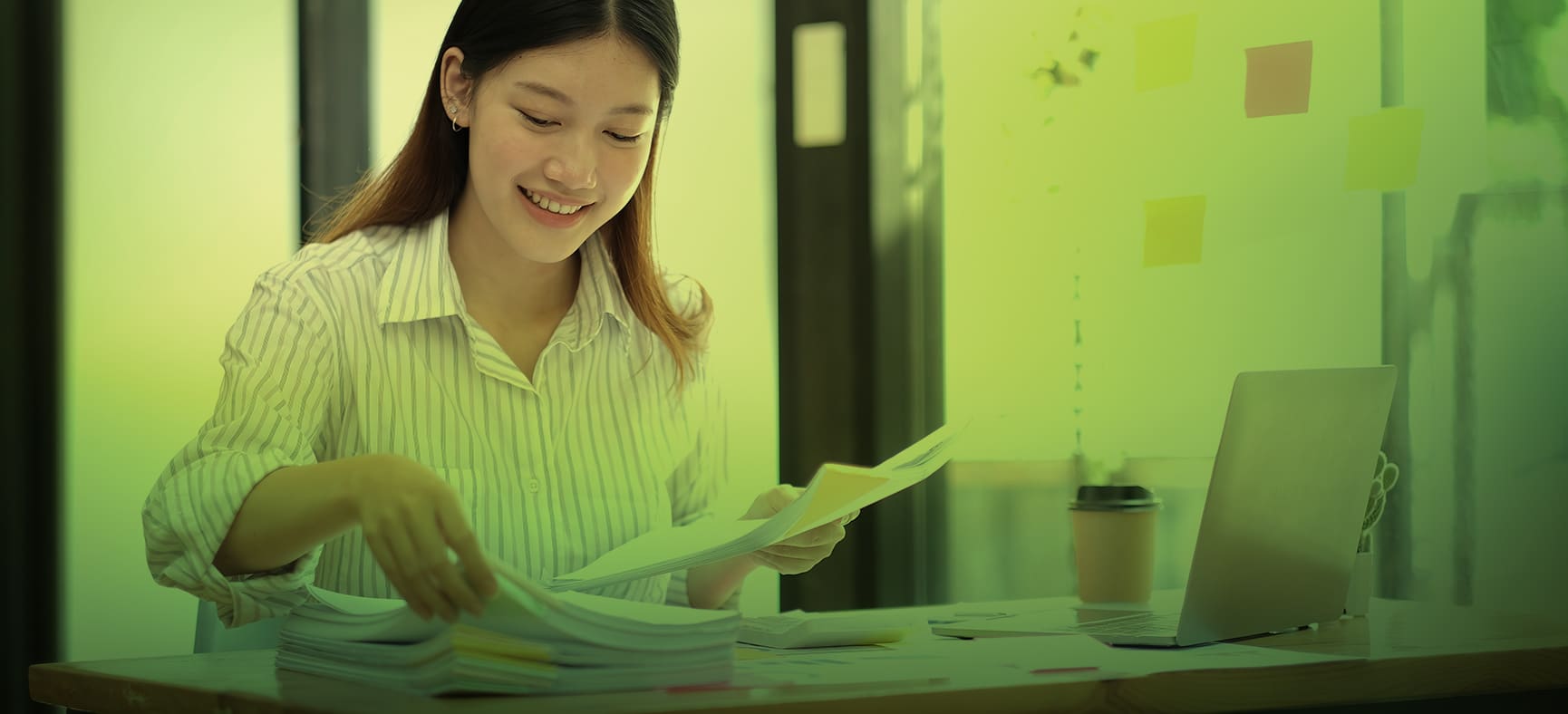 Small business owner organizes documents on her desk